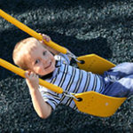 Boy Swinging in Yellow Sling Swing